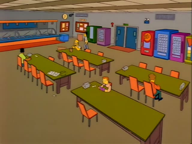 Homer stands at the back cafeteria table while a dark-haired man in a white shirt walks across the floor past the vending…