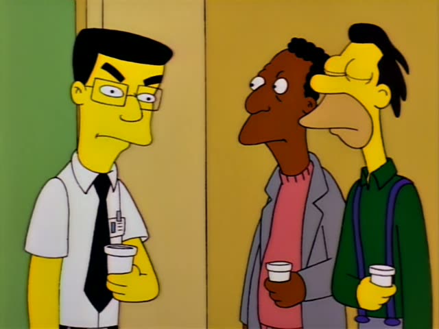 Lenny stands beside Carl, a Black man in a grey jacket over a pink sweater, while a slim man with glasses, black hair…