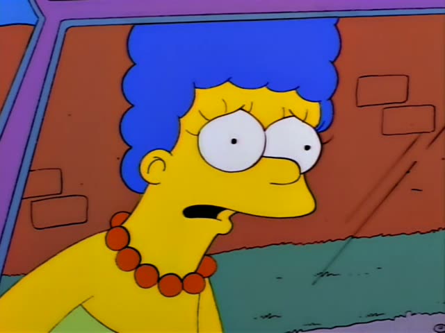 Marge Simpson sits in the back seat of a car on the left, reacting with wide eyes and an open mouth