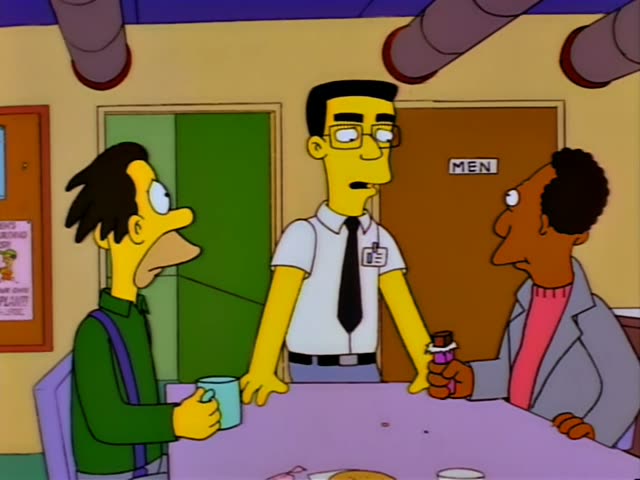A man in a green sweater and purple suspenders, holding a mint-green mug, stands with Carl and a bespectacled man in a white…