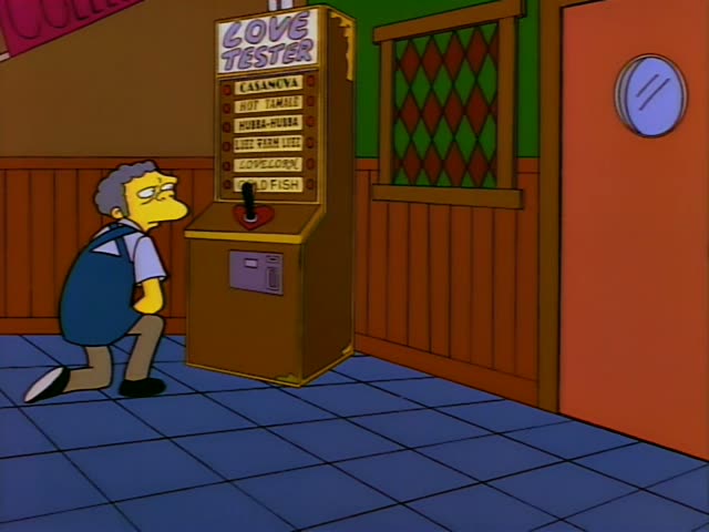 Moe leans over the Love Tester machine in his bar, then straightens and stands beside it, while a dark-haired woman…