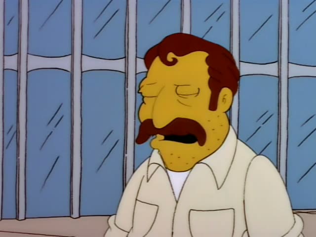 Homer stands at a street cart with a heavyset man who has a thick moustache, reddish-brown swept hair, a cream shirt…