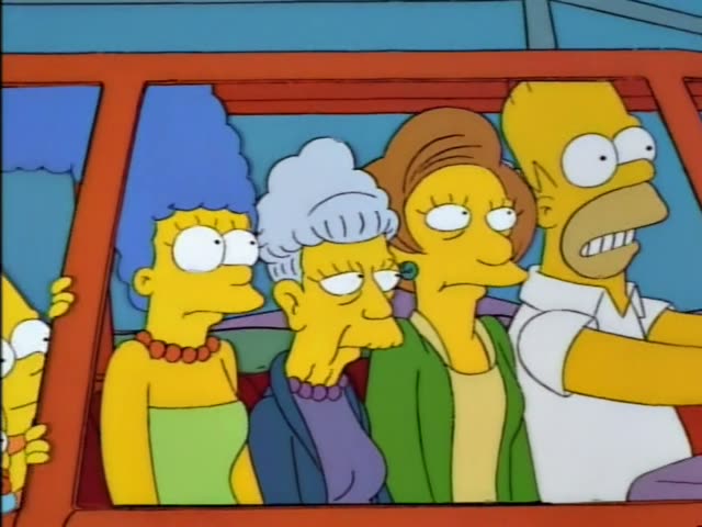 Marge with her tall blue beehive, one of her twin sisters with grey-violet hair, Mrs. Krabappel with a tall brown hairdo…