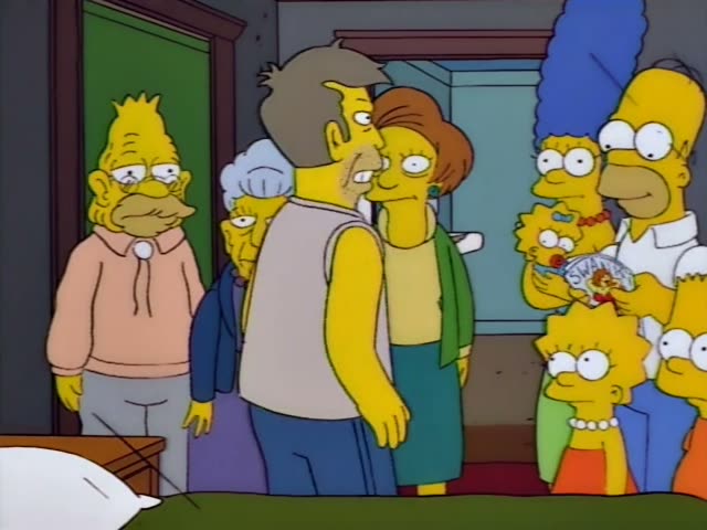 Grampa, Homer, Marge, Lisa, Bart and baby Maggie crowd into a bedroom doorway behind a stubbled man in a grey tank top…