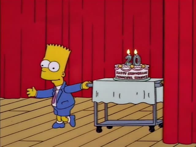 Bart in his blue suit and Milhouse in a pink shirt and blue cap wheel a rolling cart across a red-curtained stage…