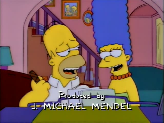 Homer Simpson and Marge Simpson sit side by side at a table in the living room, with a staircase and framed family portraits…