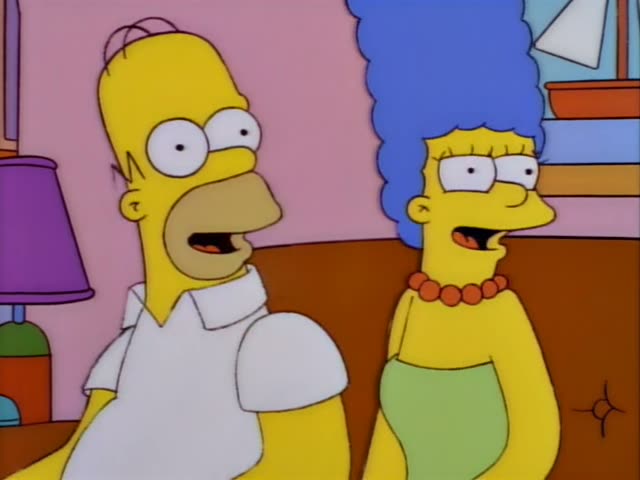Homer Simpson and Marge Simpson sit together on a brown couch in the living room