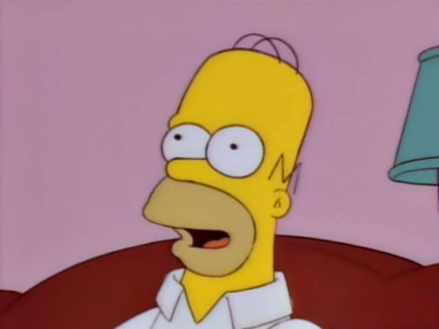 Homer sits on a red couch in a pink living room and grins with a sideways, scheming look in the early frames before blurring…