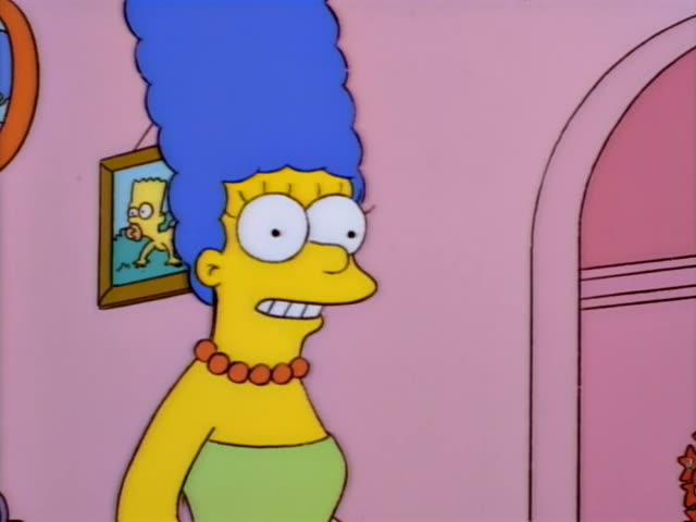 Marge hugs Bart at the front door of the house while Homer stands at the edge of the scene, and Bart then stands…