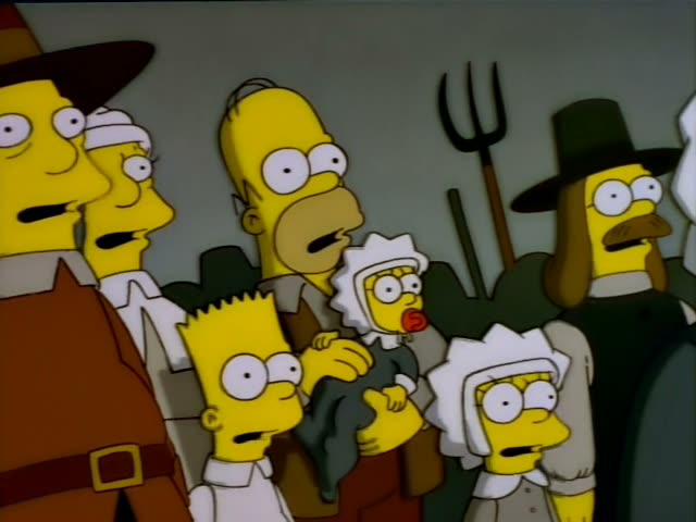 Homer stands with Bart and Lisa among a crowd of pilgrim-costumed villagers and a man with a moustache in a black hat