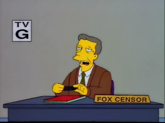 A grey-haired man in a brown jacket and green tie, labeled FOX CENSOR on his desk, sits at a desk with a red notebook…