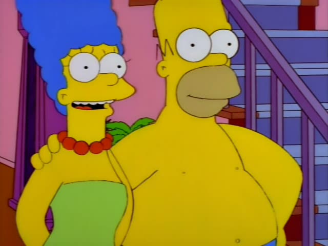 Marge stands beside a shirtless Homer in blue shorts in their pink-walled hallway, with a grandfather clock and purple…