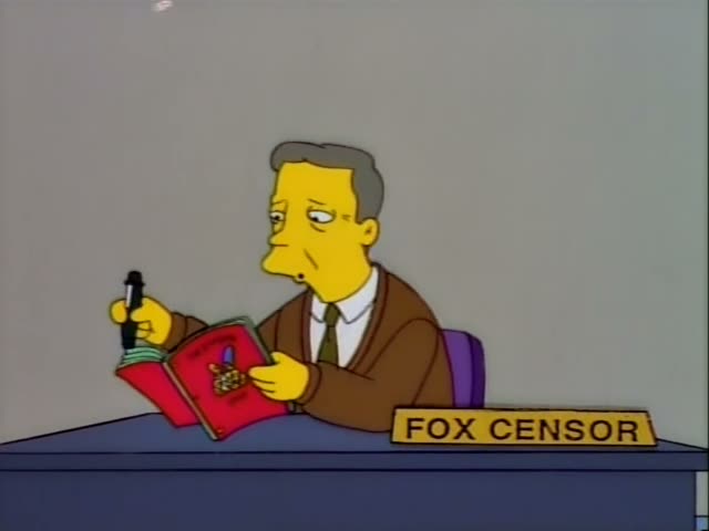 A one-off character, an older man with grey hair, a brown jacket and a green tie, sits at a blue desk marked "FOX CENSOR"…