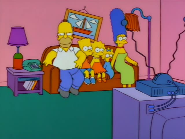 Marge Simpson stands in the living room beside the couch, and Lisa runs in from the left with her arm raised