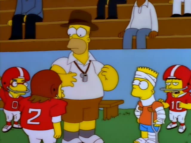 Homer stands on a grassy field with a bleacher behind him, while Bart leans on a crutch in an orange shirt and blue shorts