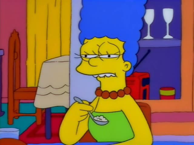 Marge Simpson sits at the table eating from a spoon in the first six frames, grimacing, chewing, and gazing sideways…