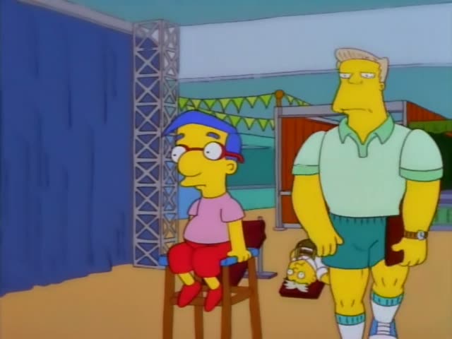 Milhouse sits on a wooden stool in a pink shirt and red shorts while a woman in a white lab coat with red hair and glasses…