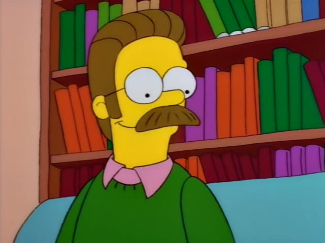Ned Flanders sits in front of a bookshelf and glances sideways with a slight smile