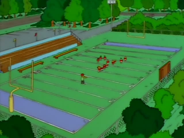 Ned Flanders stands on a grassy field beside wooden bleachers and a goalpost, first from a high aerial angle and then close…