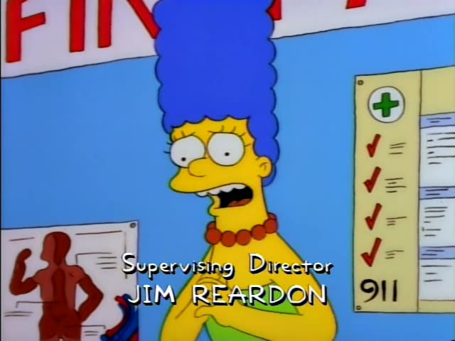 Marge Simpson stands before a fire safety poster and a 911 chart, first looking uneasy and then clasping her hands…