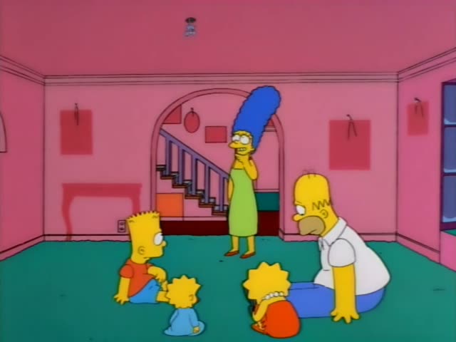 Marge stands in a pink living room with a staircase behind her, while Homer sits on the green carpet at the right