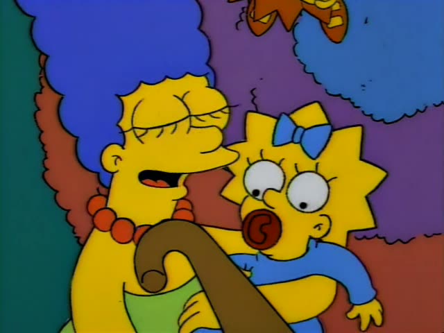 Marge with her tall blue beehive and red beads, holding Maggie in a blue bow and pacifier, grins beside a curved brown…