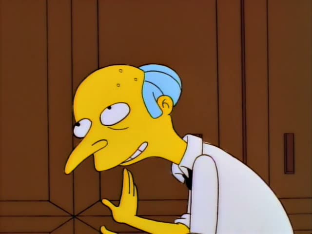 Mr. Burns stands in a richly decorated clothing shop with chandeliers, racks of coloured garments and a Santa suit on a stand