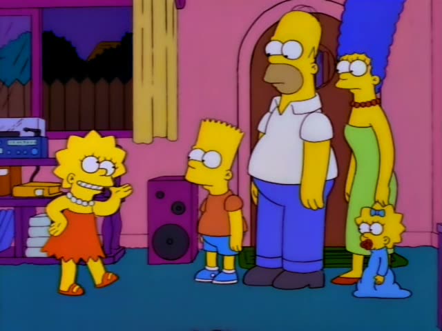 Lisa Simpson in her orange dress and pearl necklace, Bart in his orange shirt and blue shorts, Homer in his white shirt…