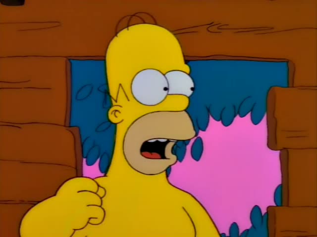 Marge scowls at the wall of a wooden cabin, and Homer pokes his head through a gap in the logs with his mouth open