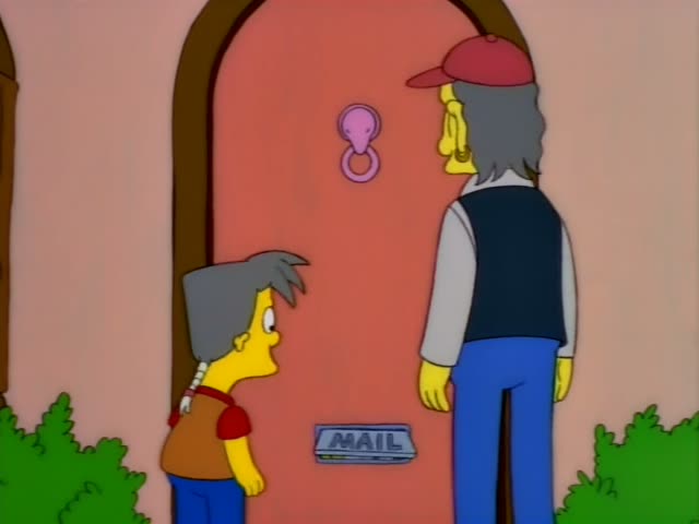 A boy with spiky grey hair and a red-orange shirt stands beside a pink arched front door with a pink knocker and a metal…
