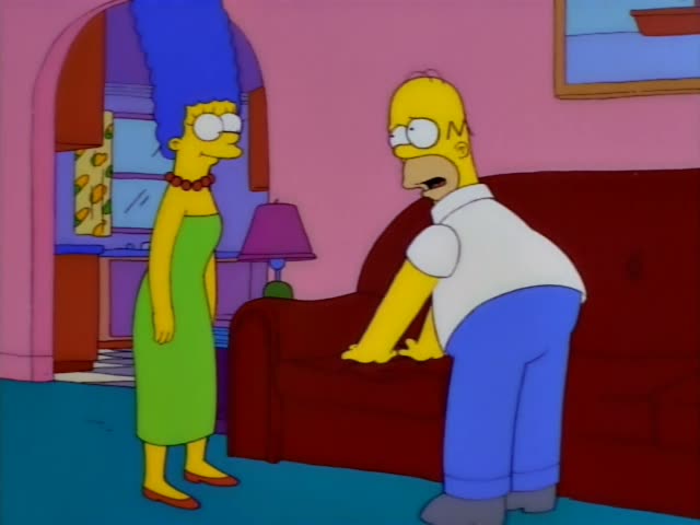 Homer Simpson and Marge Simpson stand in the pink living room beside a red couch and a purple lamp