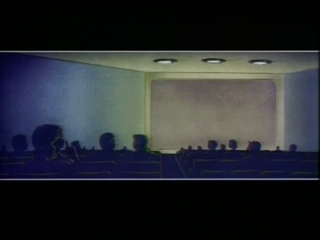 Silhouetted audience members sit in rows of theater seats watching a blank screen, with the largest figure on the left being…