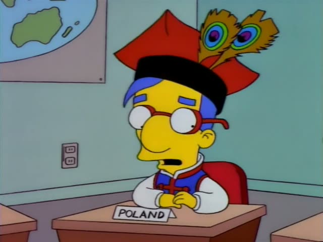 Milhouse sits at a desk labeled POLAND in a classroom with a world map on the wall