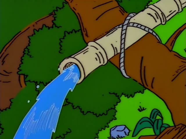 Bart slides down a tree-trunk water flume and splashes into a pool beneath a waterfall, while a figure in an orange shirt…