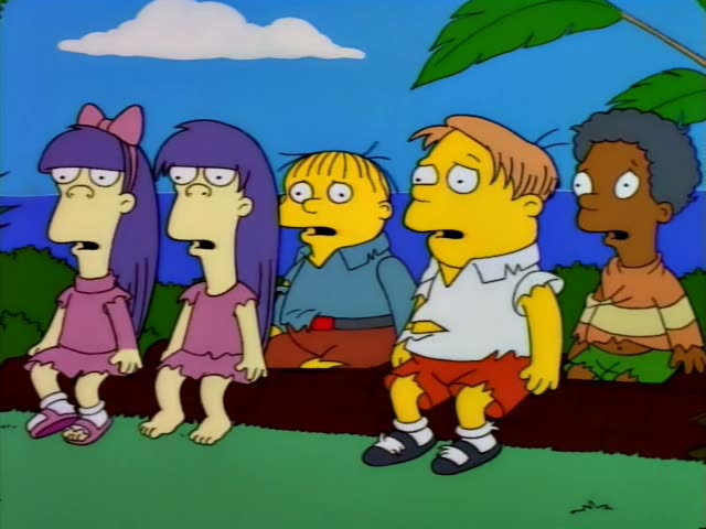 Lisa and Bart stand by a grey rock in a jungle clearing while Lisa turns to him and points, and later she gestures…