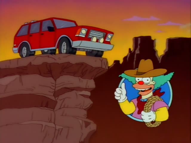 Krusty the Clown appears in a circular inset on the right, pointing one finger upward while standing against a sunset canyon…