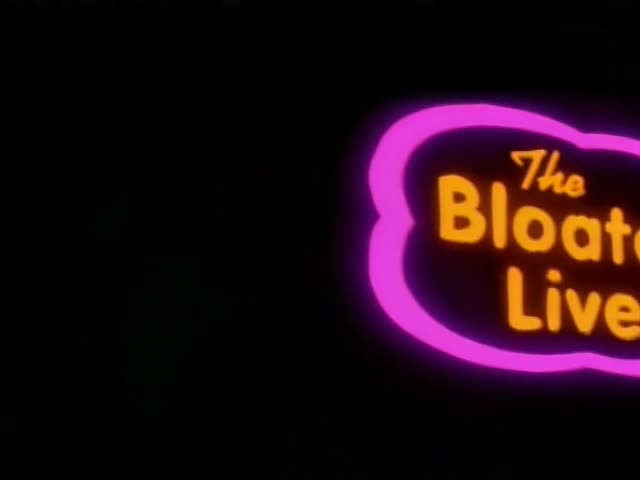 Krusty the Clown is in a dark space beside a glowing pink neon sign reading "The Bloated Liver"