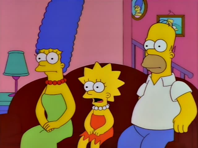 Marge with her tall blue beehive, Lisa in her red dress and pearl necklace, and Homer in his white shirt sit together…