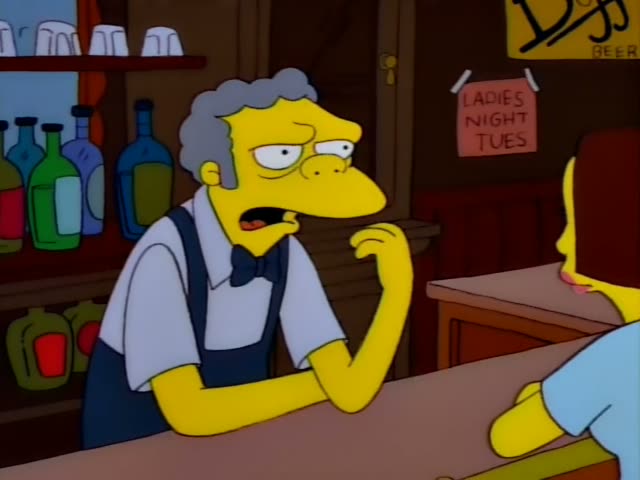 Moe leans on the bar counter across from a brown-haired patron in a light blue shirt seen from behind, with the back…