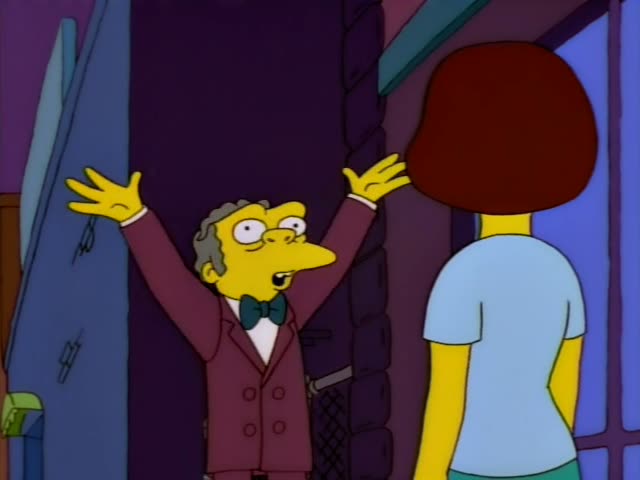 Moe first stands in a narrow alley talking with and reaching toward a woman with a reddish-brown bob and a light blue top…