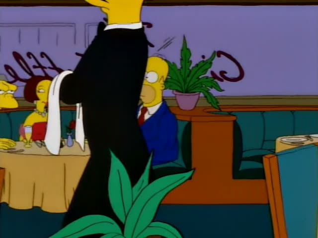 Marge and Homer sit at a restaurant table with champagne glasses
