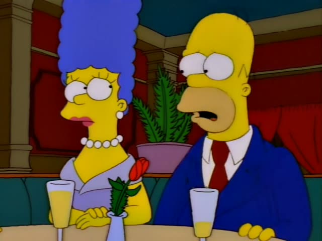 Homer and Marge sit at a restaurant table with champagne flutes and a red tulip in a vase, first with Homer talking…