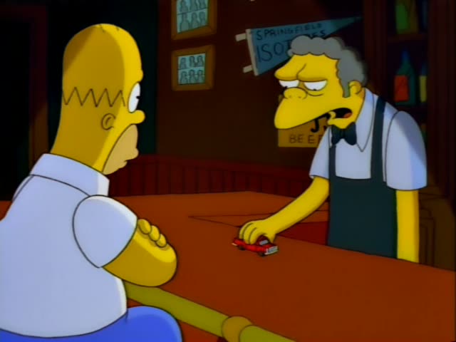 Homer sits at the bar facing Moe, the grey-haired bartender in a bow tie and dark apron, while a small red toy car sits…