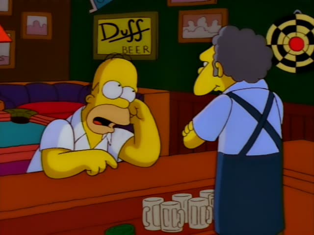 Homer Simpson leans on the bar at Moe's Tavern, with a Duff Beer sign and a dartboard on the green wall behind him