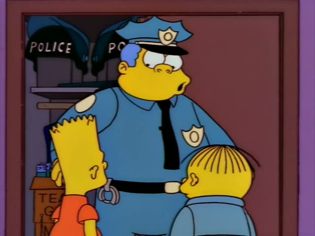 Chief Wiggum stands in a doorway lined with black caps marked POLICE and talks with Bart in his orange shirt and a small…