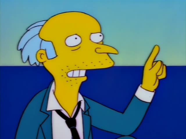 Mr. Burns stands against a blue background of sea and sky, wearing a teal suit, white shirt and dark tie