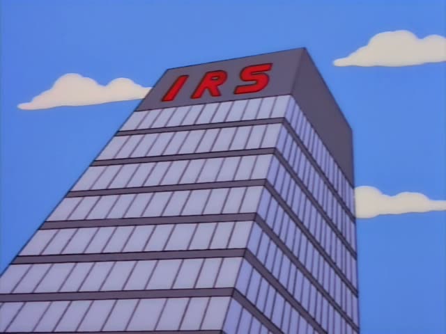 A red-haired man in a white shirt and blue tie tips a box of letters into a bin marked QUICK REFUND in the IRS mailroom…