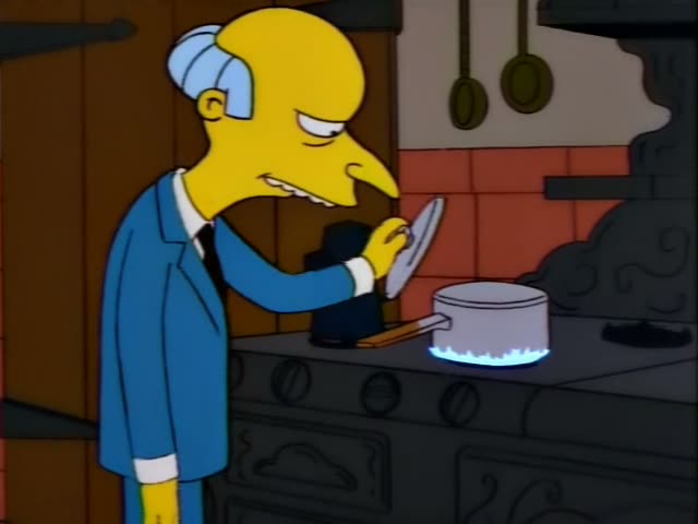 Mr. Burns stands in a kitchen by an old black stove, rubbing his hands together and then reaching toward a pot on a blue gas…