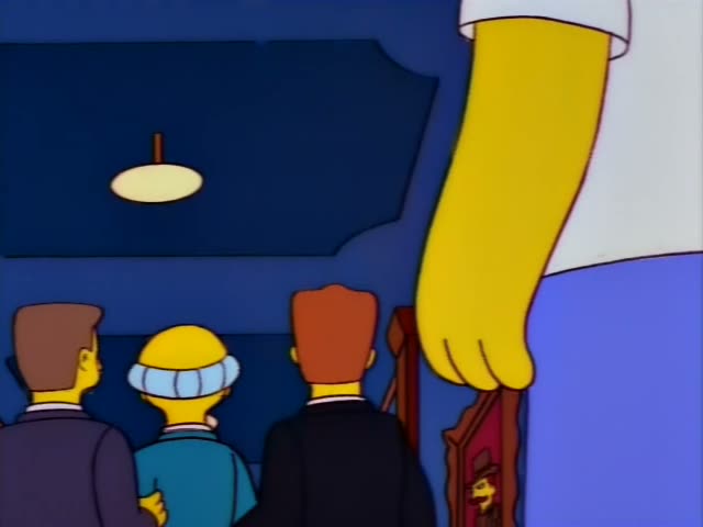 Mr. Burns walks down a blue-walled hallway with a red carpet and framed portraits, flanked by two men in dark suits, one…