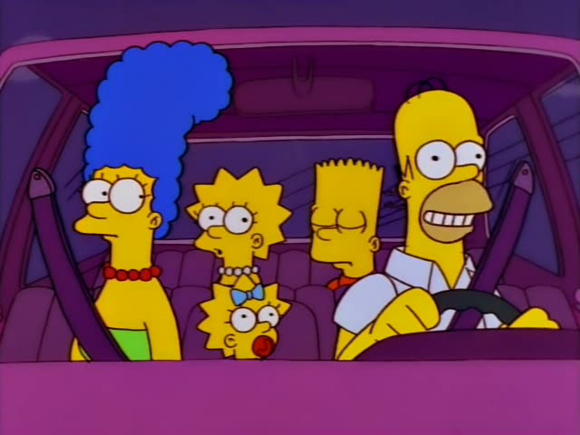 Homer, at the wheel, Marge with her tall blue beehive, Lisa, Bart and baby Maggie sit inside a pink car at night…
